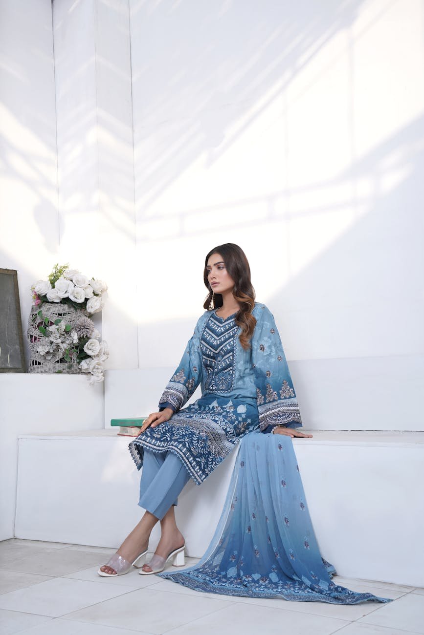 studio shot of a woman wearing an embroidered kurta and dupatta set